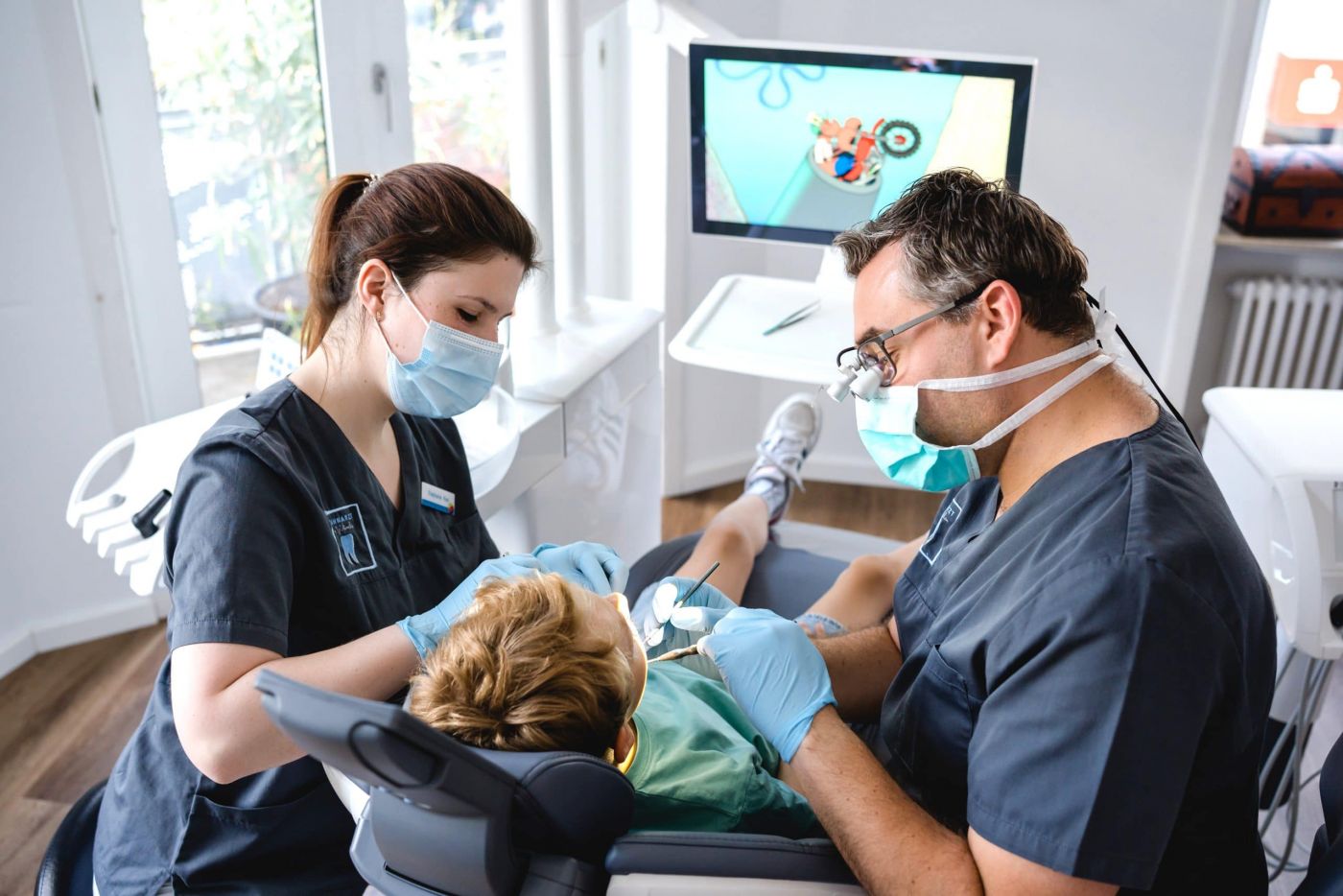 Kinderzahnbehandlung mit Zahnarzt Dennis Eigher und Medizinische Fachangestellte